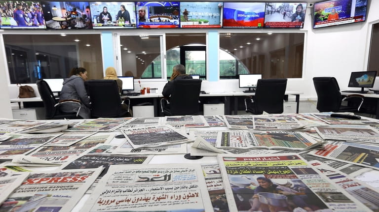 Newspapers rest on a table at a private television broadcaster...