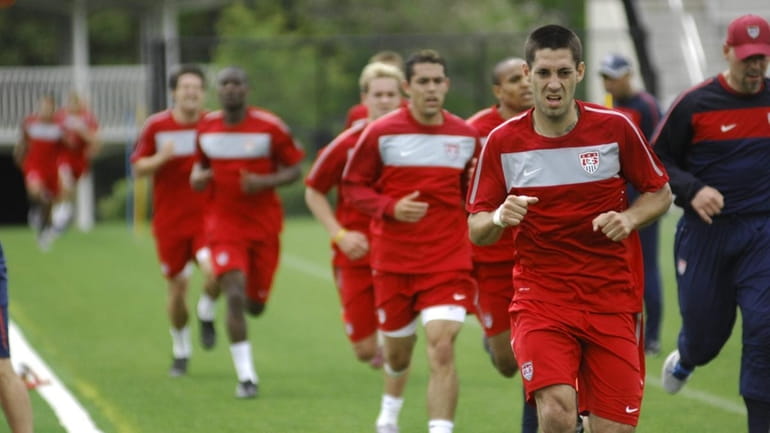 Midfielder Clint Dempsey leads the team during a running drill...