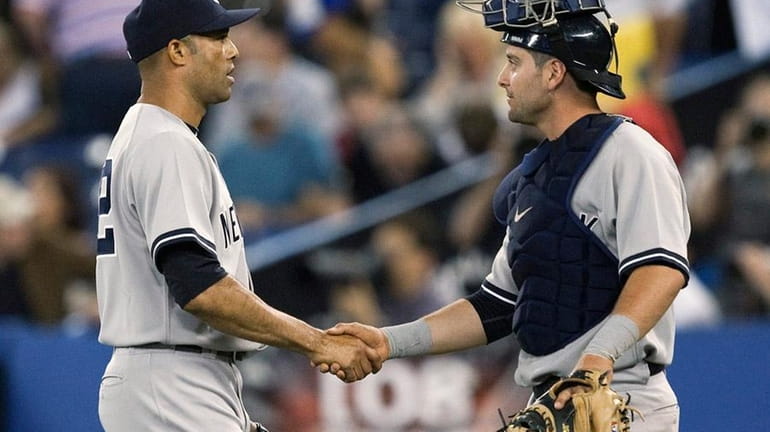 Mariano Rivera shakes hands with Francisco Cervelli after nailing down...