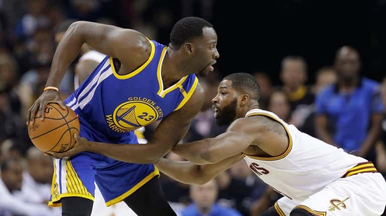 Cleveland Cavaliers center Tristan Thompson, right, defends Golden State Warriors...