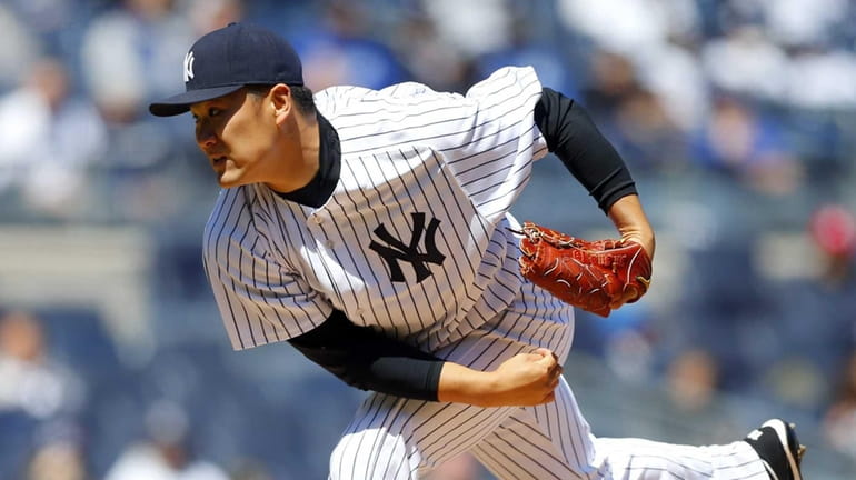 Masahiro Tanaka of the Yankees pitches in the second inning...