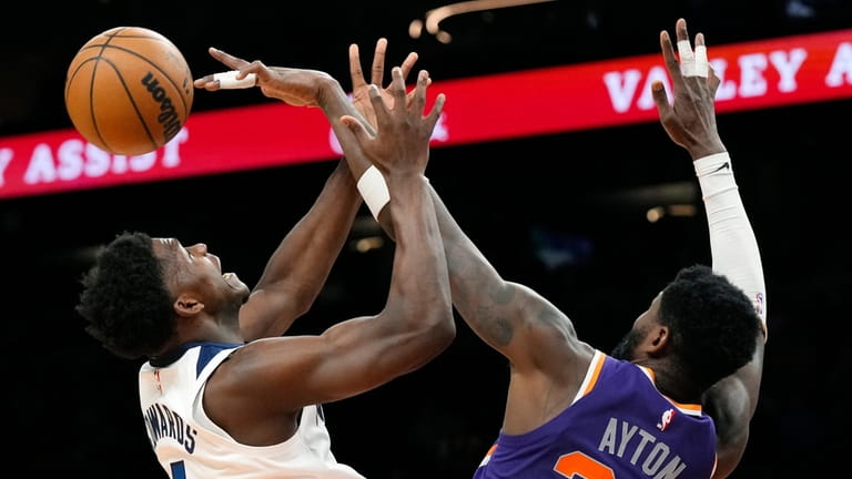 Phoenix Suns center Deandre Ayton, right, blocks a shot against...