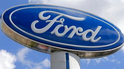 A Ford sign at an auto dealership in Hialeah, Fla.,...
