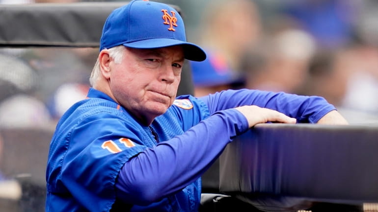Mets manager Buck Showalter (11) works in the dugout in...