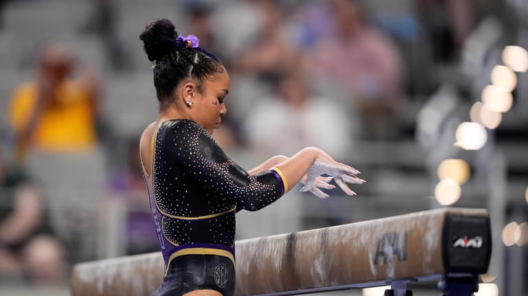 LSU's Konnor McClain begins her beam routine during the NCAA...