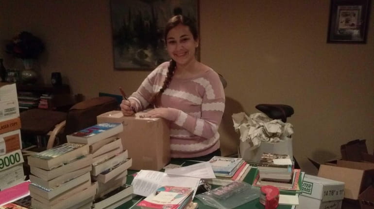 Farmingdale High School student Danielle Yostpille, 16, packs up books...
