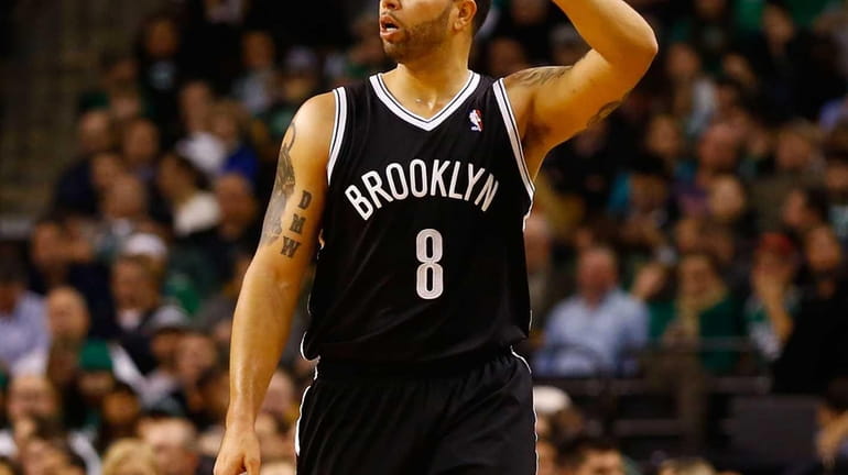 Deron Williams calls out a play while dribbling the ball...