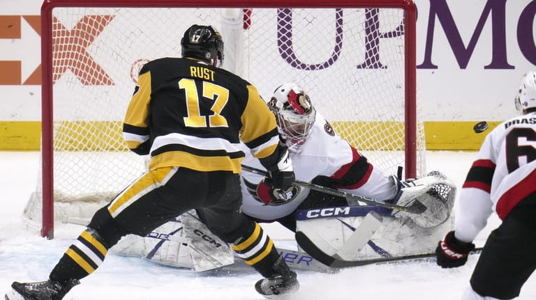 Pittsburgh Penguins' Bryan Rust (17) can't get a shot past...
