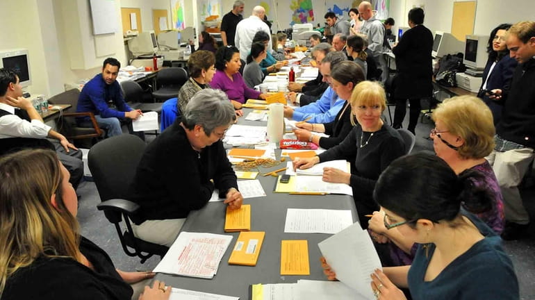 Nassau County election volunteers continue count absentee ballots in Mineola,...