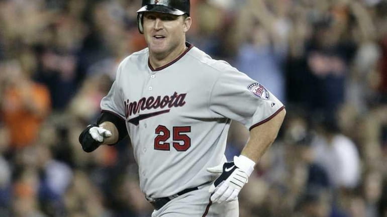 Minnesota's Jim Thome rounds the bases on his 600th career...