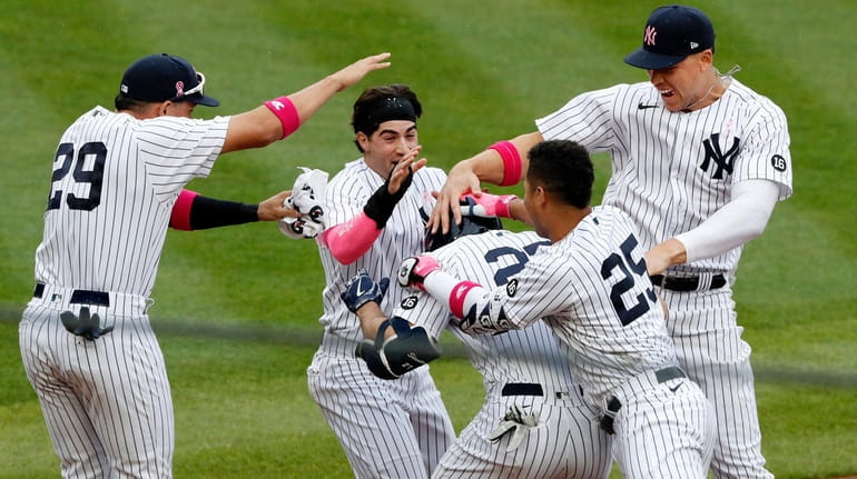 Giancarlo Stanton of the Yankees is mobbed by his teammates...
