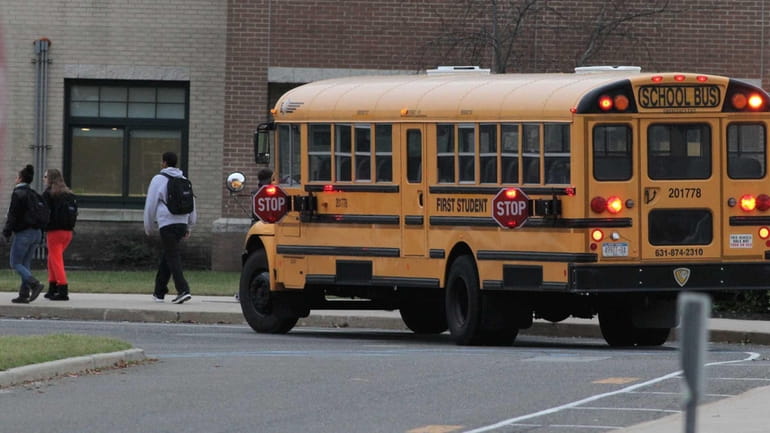 A school bus arrives with students this morning at William...