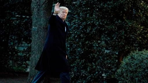 President Donald Trump waves as he arrives at the White...