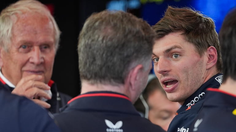 Red Bull driver Max Verstappen, right, of the Netherlands talks...