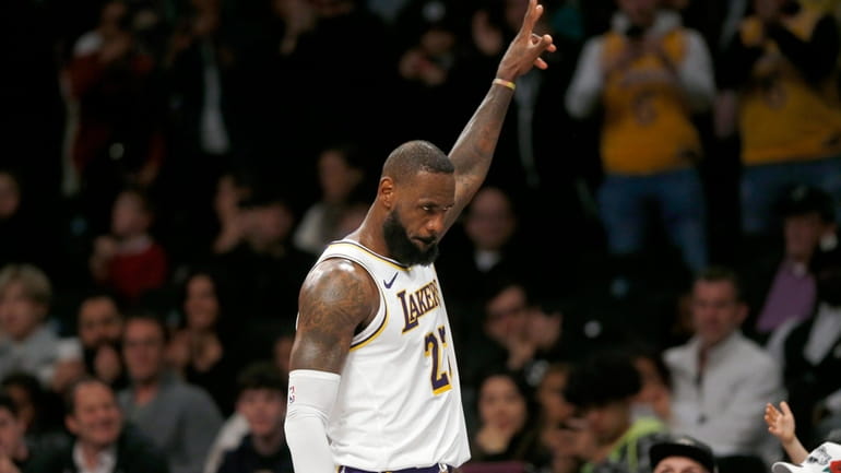 Los Angeles Lakers forward LeBron James acknowledges cheers from the...