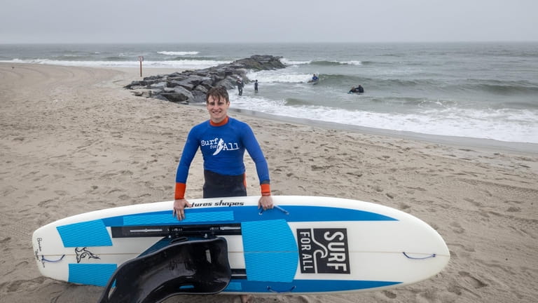 Surf for All volunteer Brandon Klein, 17, in Long Beach...