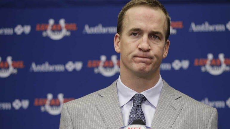 FILE - Colts quarterback Peyton Manning listens to a question...