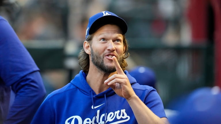 Los Angeles Dodgers pitcher Clayton Kershaw gestures in the dugout...