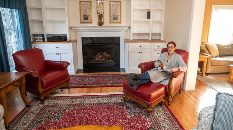 Sherri Huppert-Grassie in the living room, which features a gas fireplace...