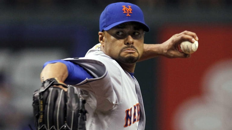 New York Mets starting pitcher Johan Santana delivers in the...