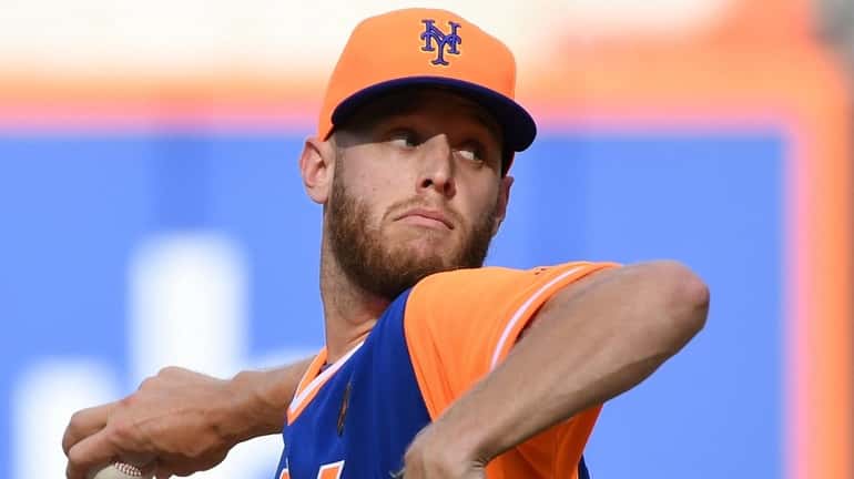 Mets starting pitcher Zack Wheeler delivers against the Nationals during the...
