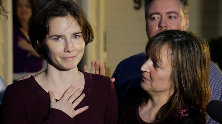 Amanda Knox, left, talks to reporters as her mother, Edda...