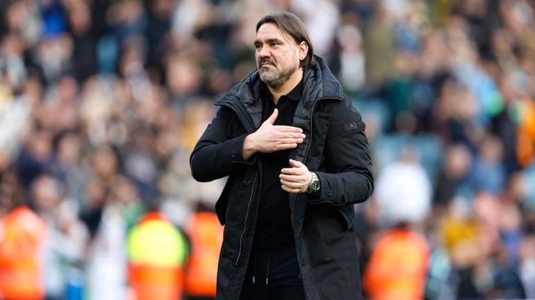 Leeds United manager Daniel Farke gestures to the fans after...