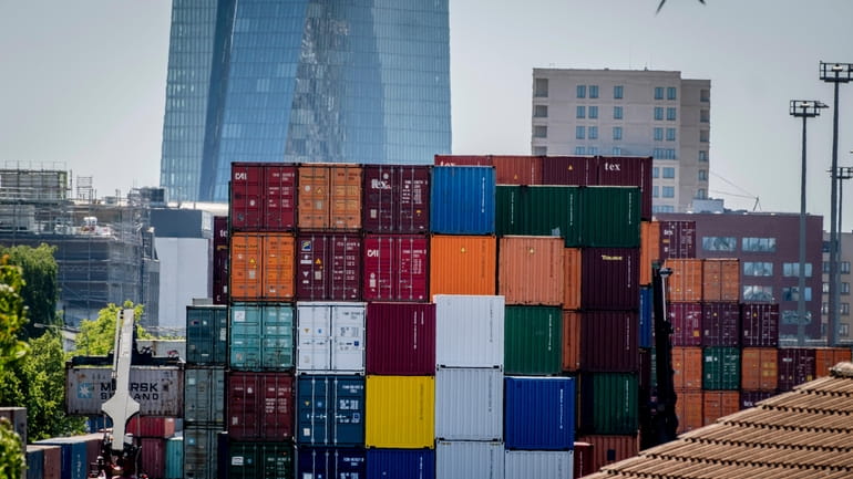 Containers are piled up at the cargo container terminal in...