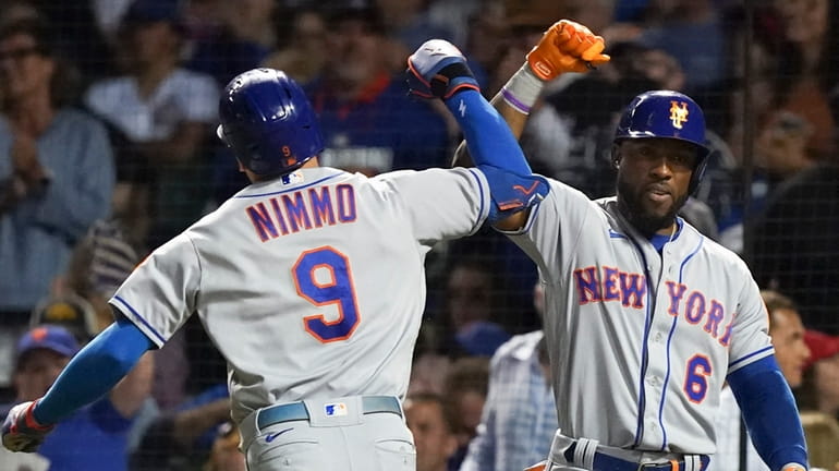 Brandon Nimmo of the Mets is congratulated by Starling Marte following...