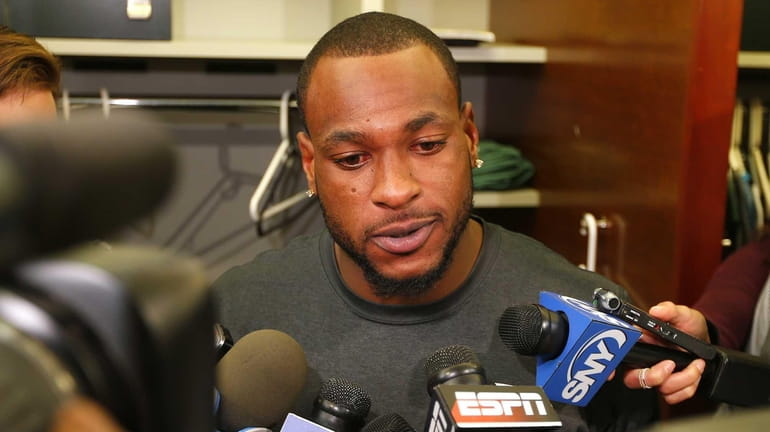 Jets receiver Percy Harvin talks to the media at his...