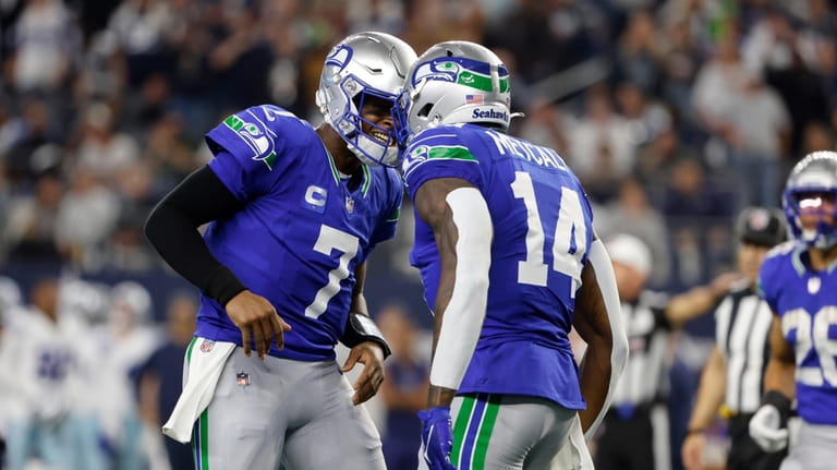 Seattle Seahawks quarterback Geno Smith (7) and wide receiver DK...