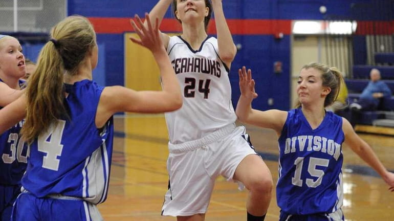 Cold Spring Harbor's Katie Durand attempts a shot between two...