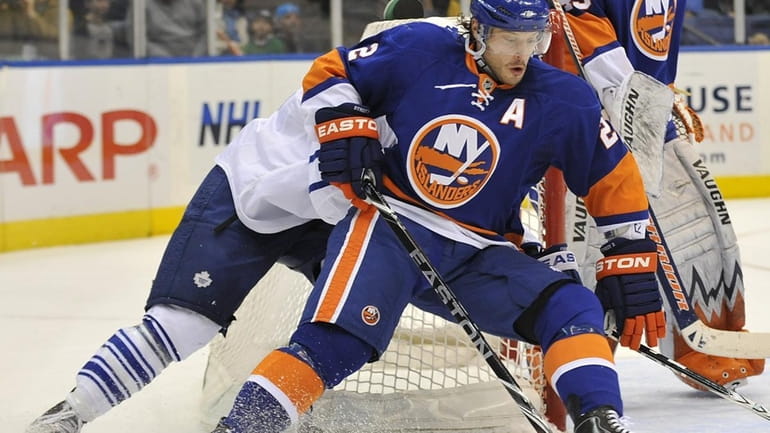 New York Islanders' Mark Streit (2) circles the net with...