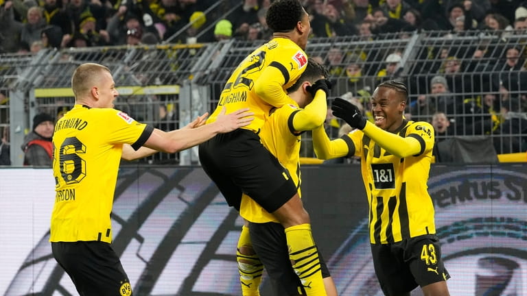 Dortmund' players celebrate with Giovanni Reyna, second right, who scored...
