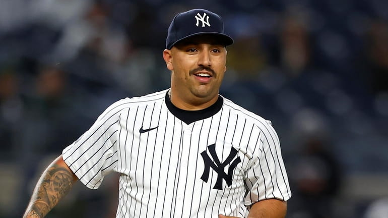 Yankees pitcher Nestor Cortes smiles before throwing against the Miami...