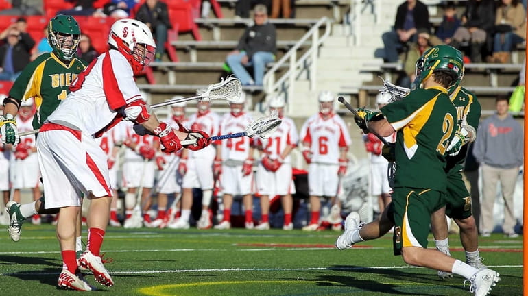 Stony Brook's Brody Eastwood shoots and scores against Siena goalie...