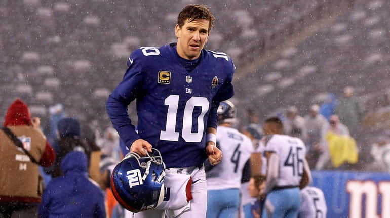 Eli Manning of the New York Giants runs off the...