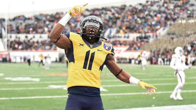 West Virginia wide receiver Kevin White celebrates following a touchdown...