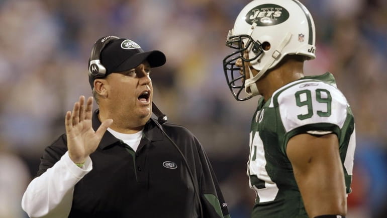 New York Jets head coach Rex Ryan, left, talks with...