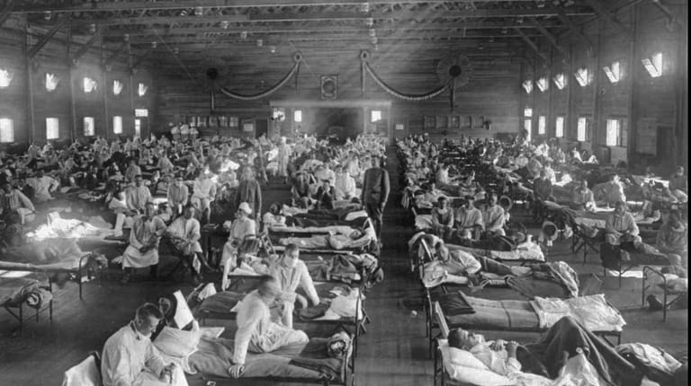 Influenza patients crowd into an emergency hospital near Fort Riley, Kansas,...