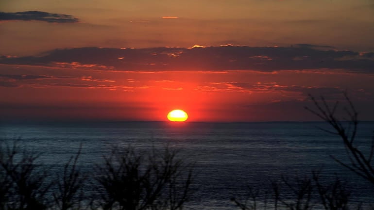 The sun just breaking the horizon at Montauk Point on...