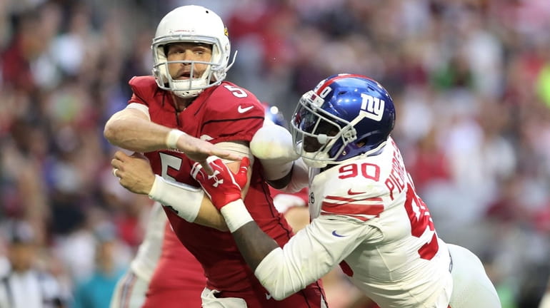 Quarterback Drew Stanton of the Cardinals is hit by defensive...