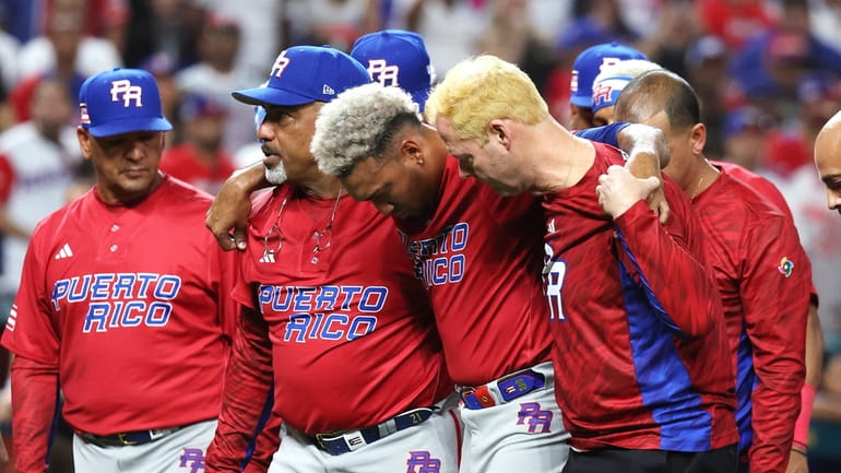 Edwin Diaz of Team Puerto Rico is carried off the...
