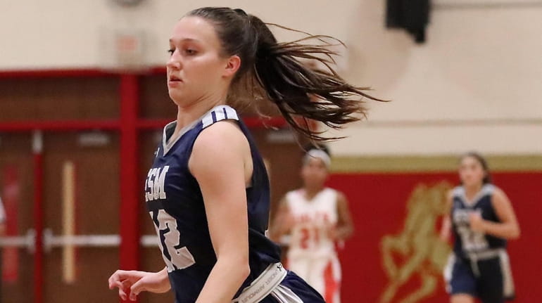 Eastport-South Manor's Casey Travers goes in for two points after...