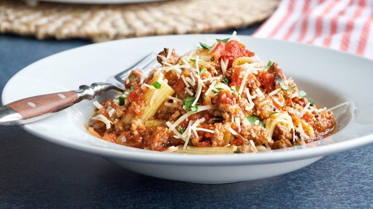 Bolognese-like sauce is made in the slow cooker, served over...