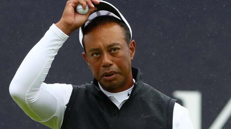 Tiger Woods reacts on the 18th during the second round...