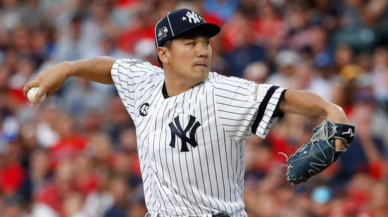 American League pitcher Masahiro Tanaka, of the Yankees, throws during the...