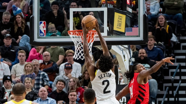 Utah Jazz guard Collin Sexton (2) shoots while guarded by...