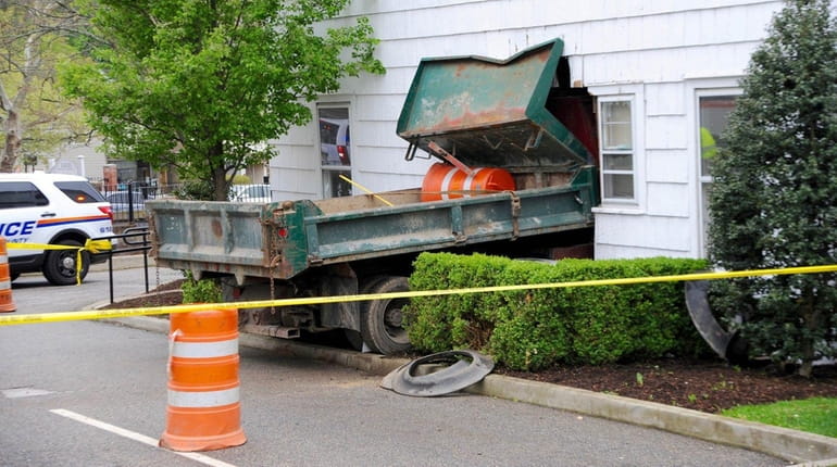 A construction dump truck plowed into a Roslyn building on...