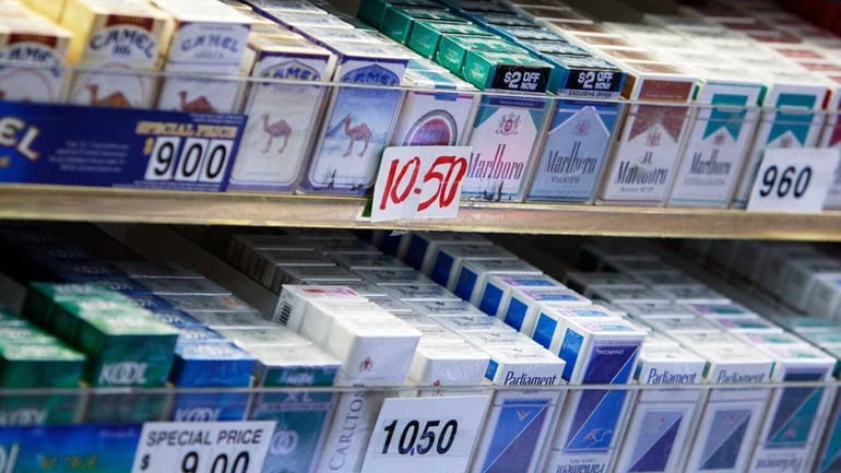 Cigarette packs are on display for sale.
